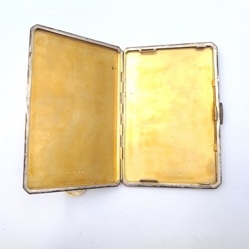 512 - A heavy gauge sterling silver gilt cigarette case with engine turned detailing. Dimension - 13.8 1/2... 