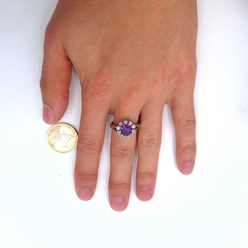 515 - Super Star Lot: An excellent example of a finely polished 18ct white gold amethyst and diamond surro... 