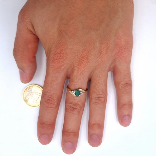 525 - Star Lot : A nice example of an emerald and diamond set ring. Mounted in nine carat gold. Ring size ... 