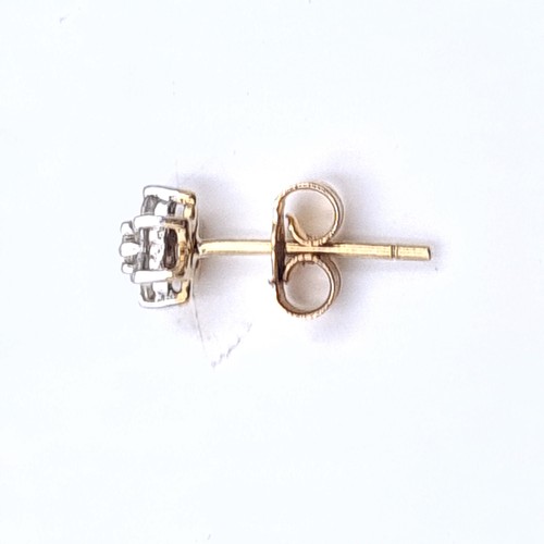 526 - A pair of nine carat gold diamond set stud earrings. Weight .96 grams.