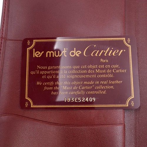 599 - Star Lot : An original very handsome Designer Cartier burgundy leather travel wallet with Cartier ce... 