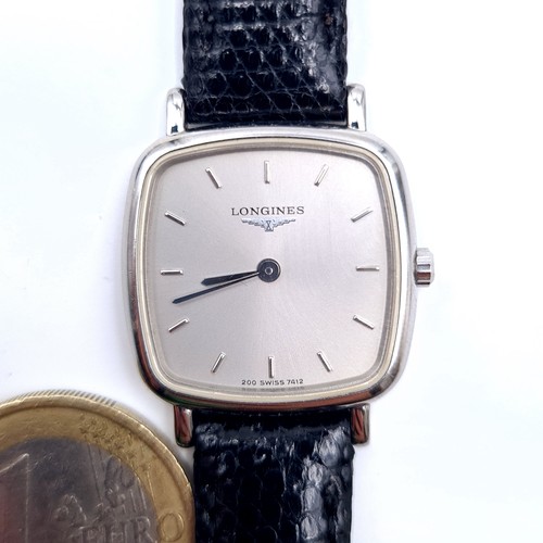 600 - Star Lot : An original Longines mid size wrist watch with leather strap. Inscription 