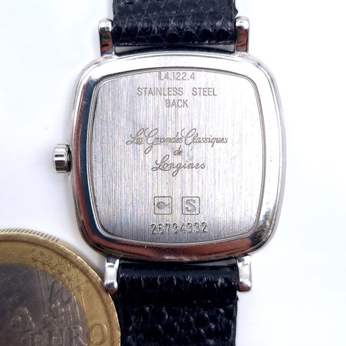 600 - Star Lot : An original Longines mid size wrist watch with leather strap. Inscription 