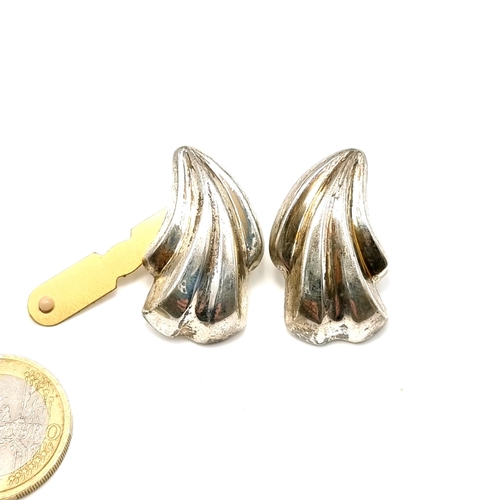 23 - A pair of sterling silver scalloped design stud earrings. Length - 3 cms. Weight - 8 grams.