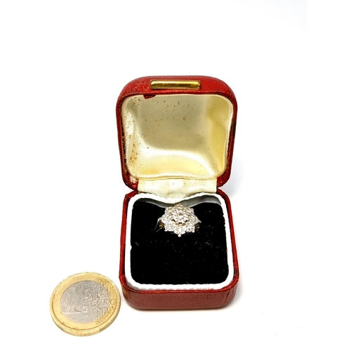 48 - Star Lot : A very nice example of a diamond cluster ring set in 18 carat white gold marked 750. Est.... 