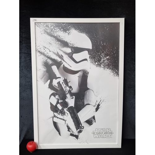 733 - A large print of 'Star Wars: Episode VII, The Force Awakens Stormtrooper'. Housed in a white frame .... 