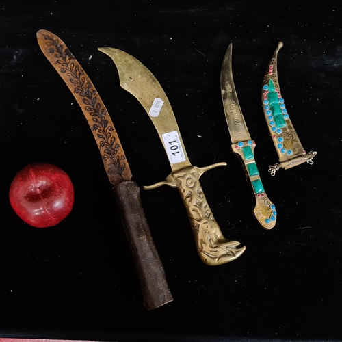 101 - Three interesting knives comprising of one wooden dagger with hand painted floral detailing, a brass... 