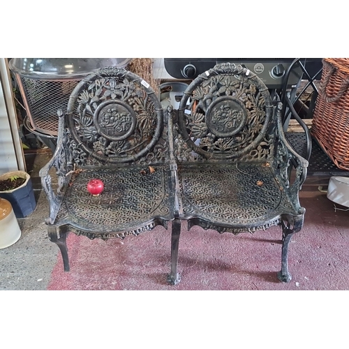 702 - Star lot : An Antique very fine Cast iron garden bench with intricate floral and cherub motif design... 