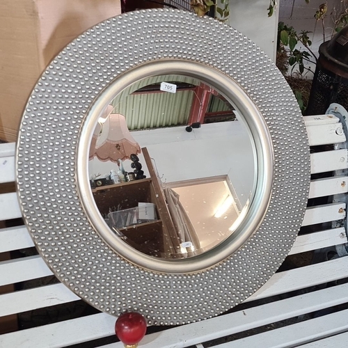 705 - Round decorative wall mirror with a textured metal frame and a beaded design.