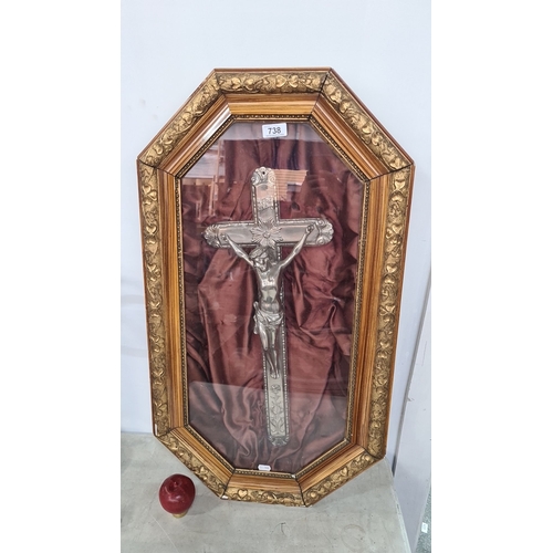 738 - A large bubble Framed crucifix, featuring a detailed silver-tone Jesus figure on a cross. Set in a g... 