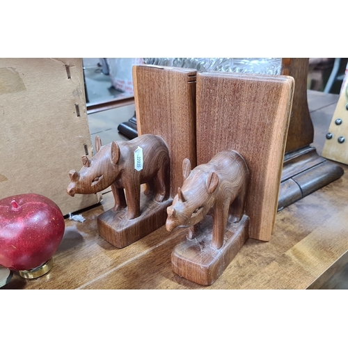 742 - Pair of hand-carved wooden rhinoceros bookends. Exquisitely crafted with intricate details, showcasi... 