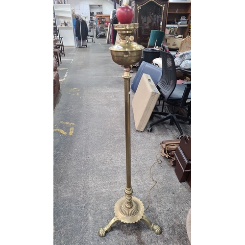 747 - Antique Victorian brass oil lamp on a tripod base with detailed embellishments. Converted to electri... 