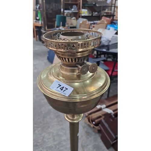 747 - Antique Victorian brass oil lamp on a tripod base with detailed embellishments. Converted to electri... 