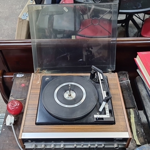 752 - A vintage Ferguson Unit Audio record player. Has a wood veneer finish and integrated controls. Inclu... 