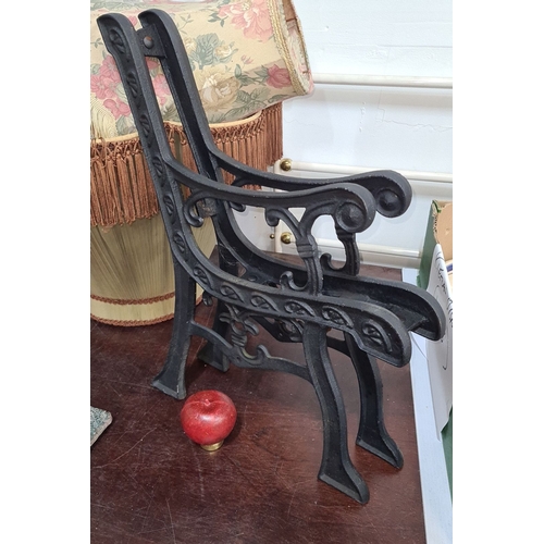 762 - A Pair of cast iron ornate bench ends, featuring intricate scroll and leaf patterns.