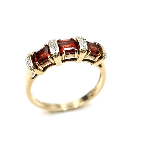 Star Lot : A good garnet and diamond set ring set in nine carat gold (375) Ring size - Q. Weight - 3 grams. Boxed.