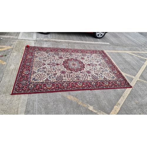 817 - Star lot : Persian-style hand-knotted rug, intricate floral pattern with rich red, blue, and ivory t... 