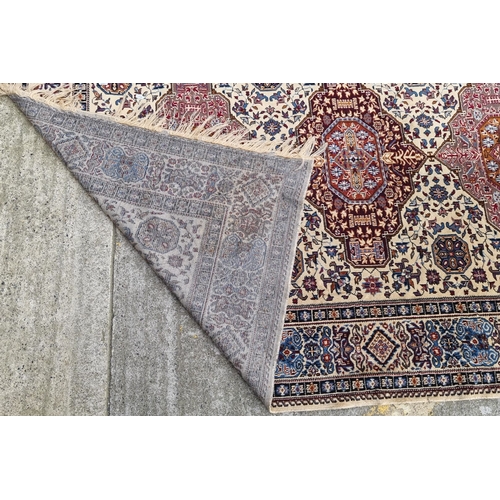 821 - Star lot : Hand-knotted Persian-style rug with intricate geometric and floral patterns in red, blue,... 