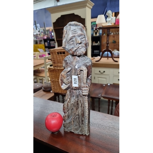 828 - Hand-carved wooden figurine of a bearded man holding a staff. Intricately detailed, showcasing skill... 