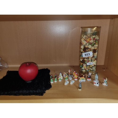 853 - A large assortment of miniature ceramic figures including the nativity scene and a tube full of mixe... 