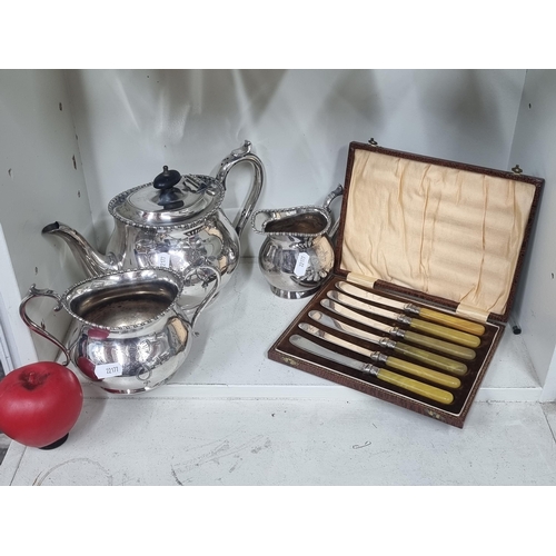 858 - A lot of silver plated items including a teapot, pitcher along with six knives housed in original pr... 