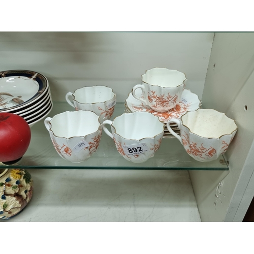 892 - An antique 11 piece cup and saucer set with floral detailing and gilt gold rims. Unmarked.