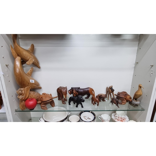 893 - A nice collection of hand carved wooden animals including an elaborate dolphin piece and smaller exa... 