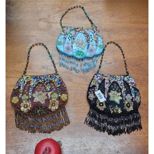 898 - Three vibrant beaded evening bags with fringe details.