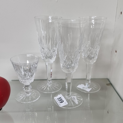 899 - Three Waterford 'Lismore Flute' glasses. Features the iconic Lismore cut. Along with a 'Waterford Ei... 