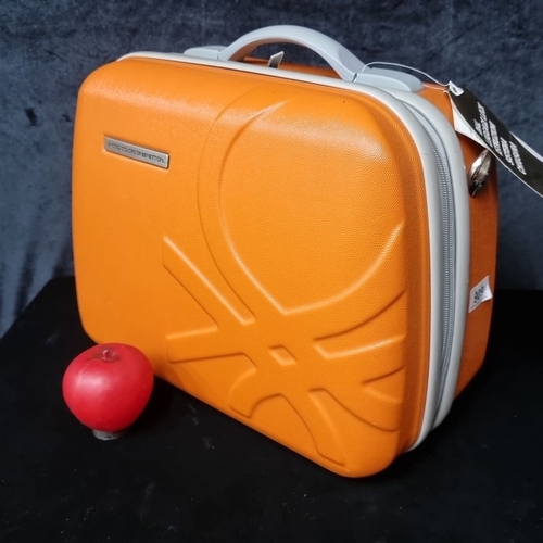 909 - United Colors of Benetton orange hard-shell suitcase with grey interior, featuring organized compart... 