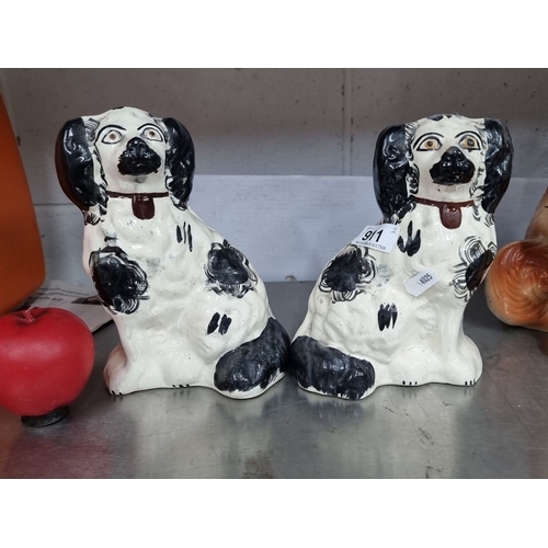 911 - Pair of hand-painted Staffordshire-style ceramic spaniel figurines. Predominately white with black p... 