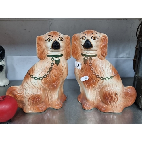 912 - Pair of Victorian Staffordshire Spaniel figurines, hand-painted ceramic, featuring orange and white ... 