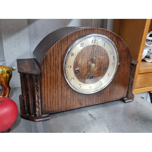 915 - Wooden mantel clock with Art Deco design and brass movement and chime. It features a domed top and f... 