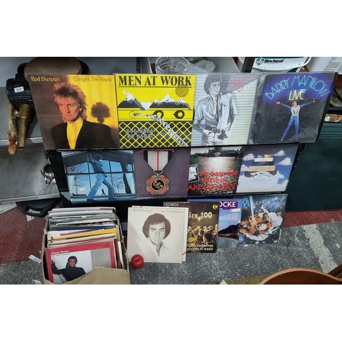 916 - Collection of twelve vintage vinyl records, featuring artists such as Rod Stewart, Men at Work, Barr... 