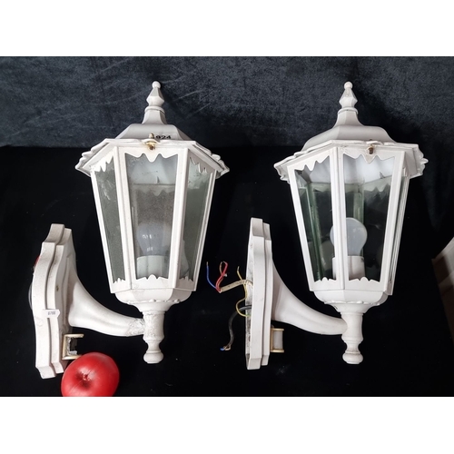 924 - Pair of vintage white wall-mounted lanterns, featuring six glass panels and decorative finials.