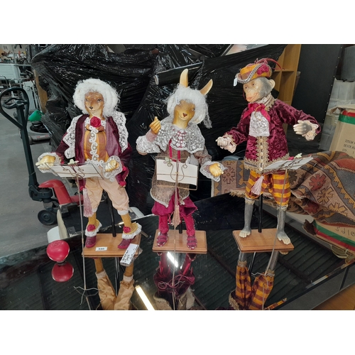 940 - A trio of whimsical tall animal sculptures in period attire each in the pose of a conductor with a f... 