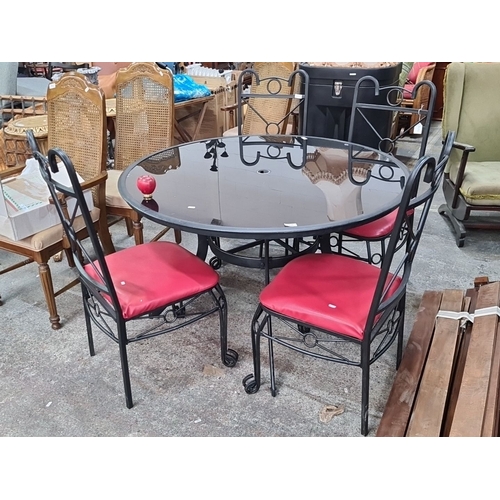 768 - Star Lot : A  handsome garden black wrought iron patio set with a round glass-top table and four tal... 