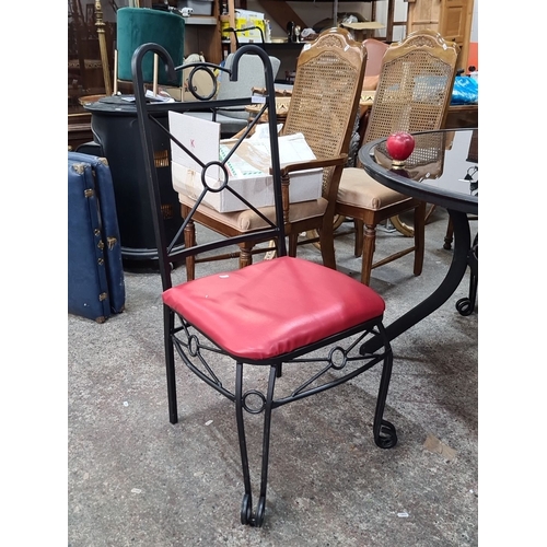 768 - Star Lot : A  handsome garden black wrought iron patio set with a round glass-top table and four tal... 