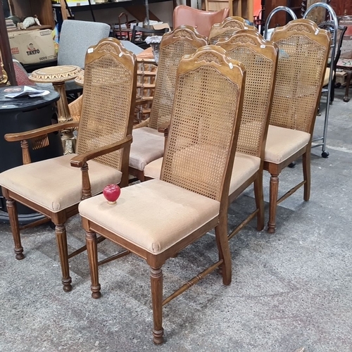 772 - Four cane-back wooden dining chairs with upholstered seats, featuring detailed carving and turned le... 