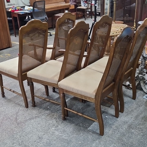 772 - Four cane-back wooden dining chairs with upholstered seats, featuring detailed carving and turned le... 