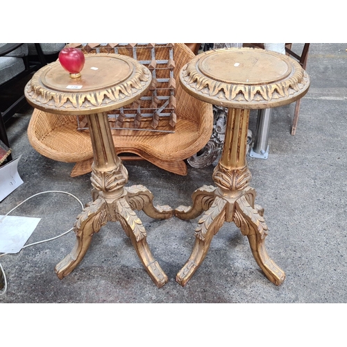 776 - Star Lot : A super Pair of carved giltwood pedestal tables featuring intricate foliage detailing, th... 