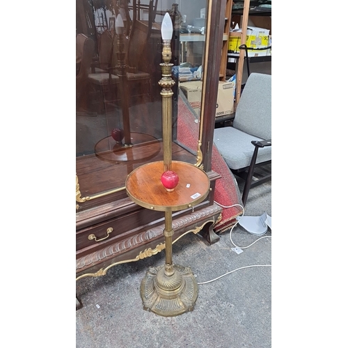 781 - Antique brass floor lamp with integrated wooden side table. Features detailed engravings and fluted ... 