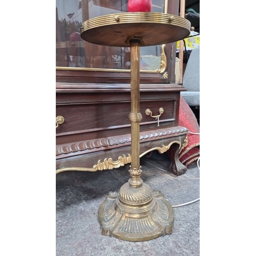 781 - Antique brass floor lamp with integrated wooden side table. Features detailed engravings and fluted ... 