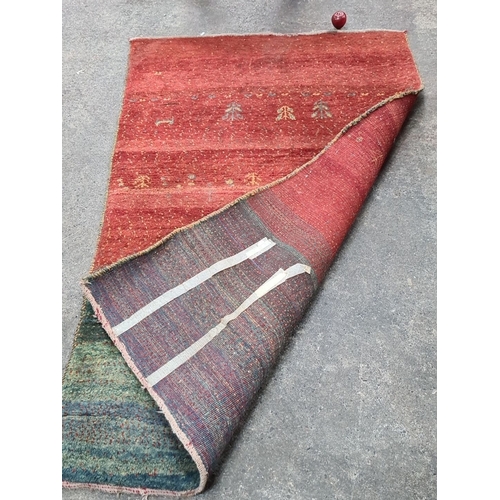 783 - Star lot : Handwoven wool rug featuring a striking gradient design in red and green hues with intric... 