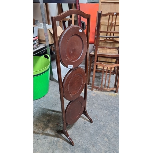 787 - Three-tier mahogany folding plant stand, likely early 20th century, featuring round plate shelves an... 