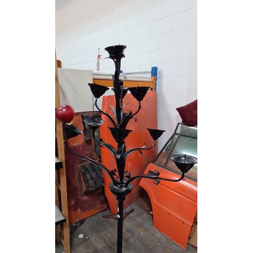 794 - Wrought iron floor-standing candelabrum with floral motif detailing. Black finish. Approximately 5 f... 