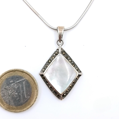 1008 - A sterling Silver Mother of Pearl with Marcasite. Stamped 925 both Chain and Pendant. Boxed.
Total L... 