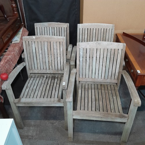 965 - Four wooden  teak stackable patio / garden dining chairs. All in good order no breaks or damage.