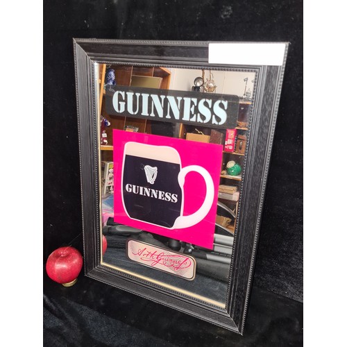 707 - A Guinness advertising pub mirror depicting the iconic Guinness tankard painted within the glass. Ho... 