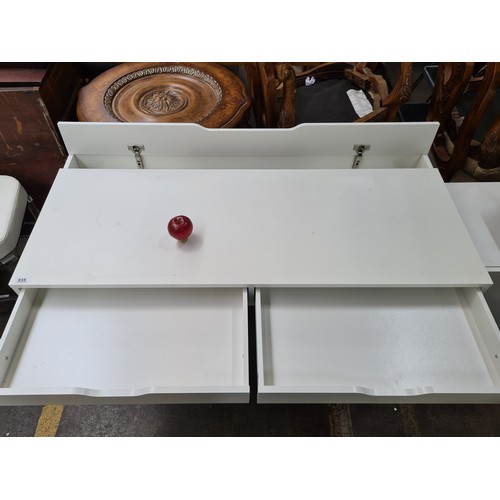 935 - A white wooden desk with two pull out drawers and a hinged desk lid  for hiding cables. 150 Euro ret... 